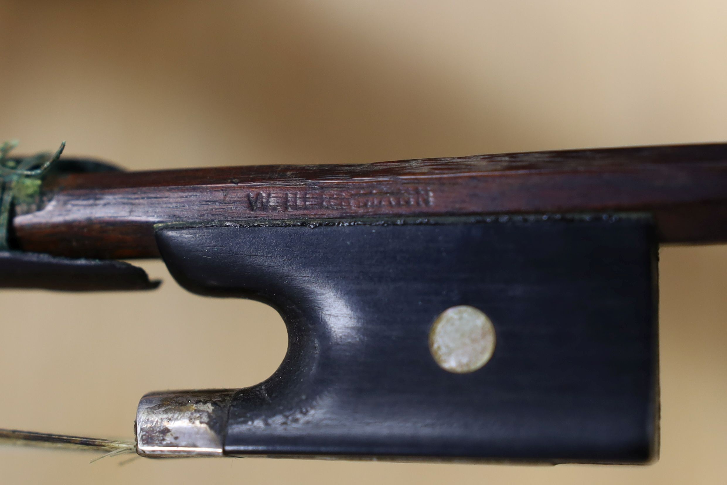 A 19th century violin labelled JB Guadagnini, back measures 35cm, with two bows, one silver-mounted.